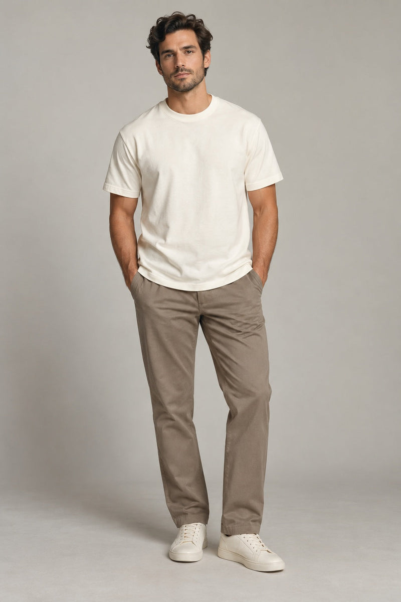 Male model wearing essential crewneck t-shirt in ivory on a neutral studio background