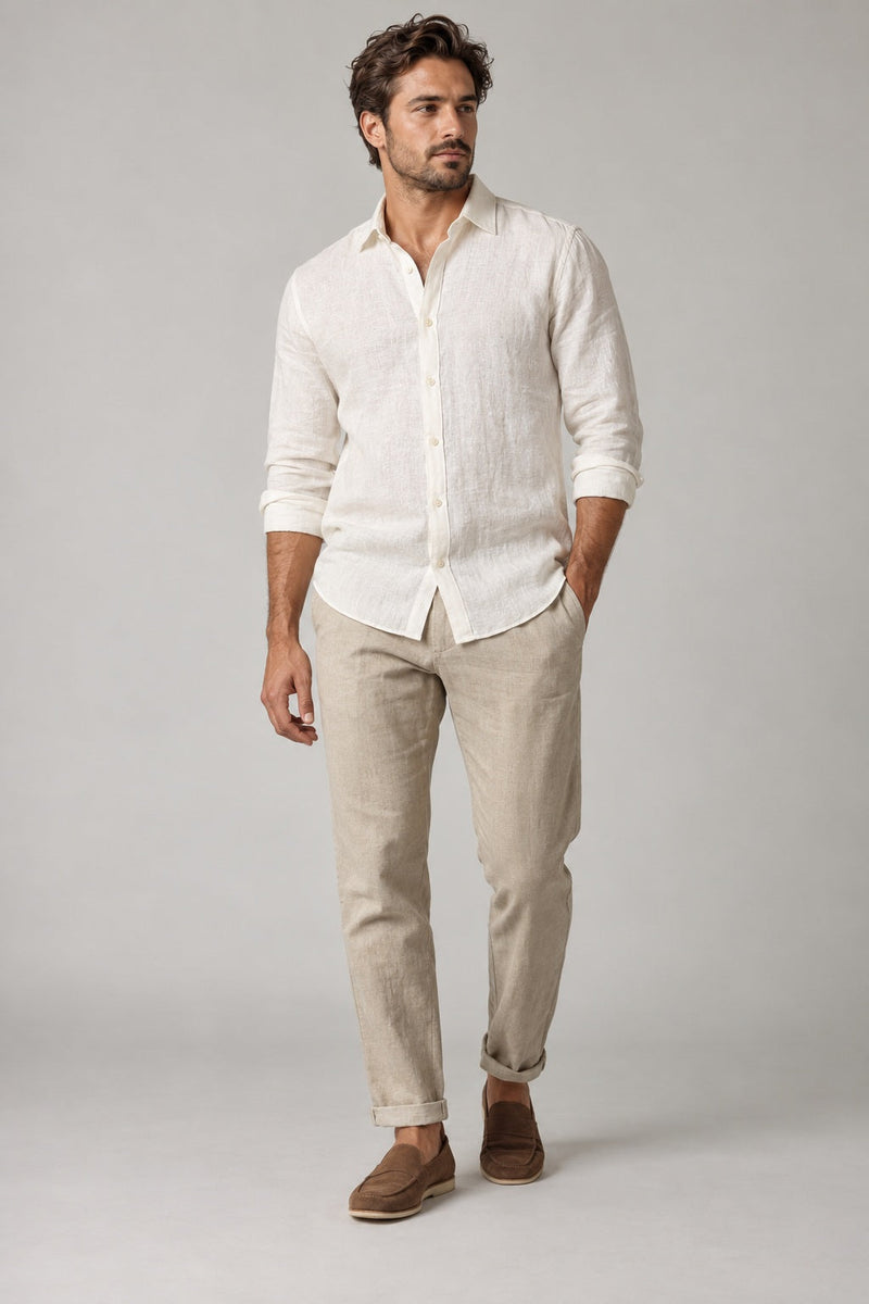 Male model wearing relaxed summer shirt in white on a neutral studio background
