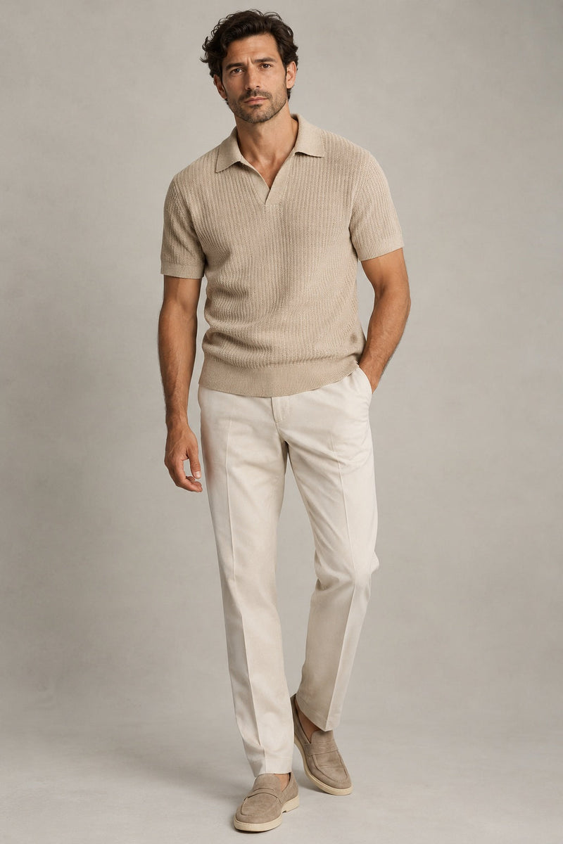 Male model wearing textured knit polo in sand on a neutral studio background