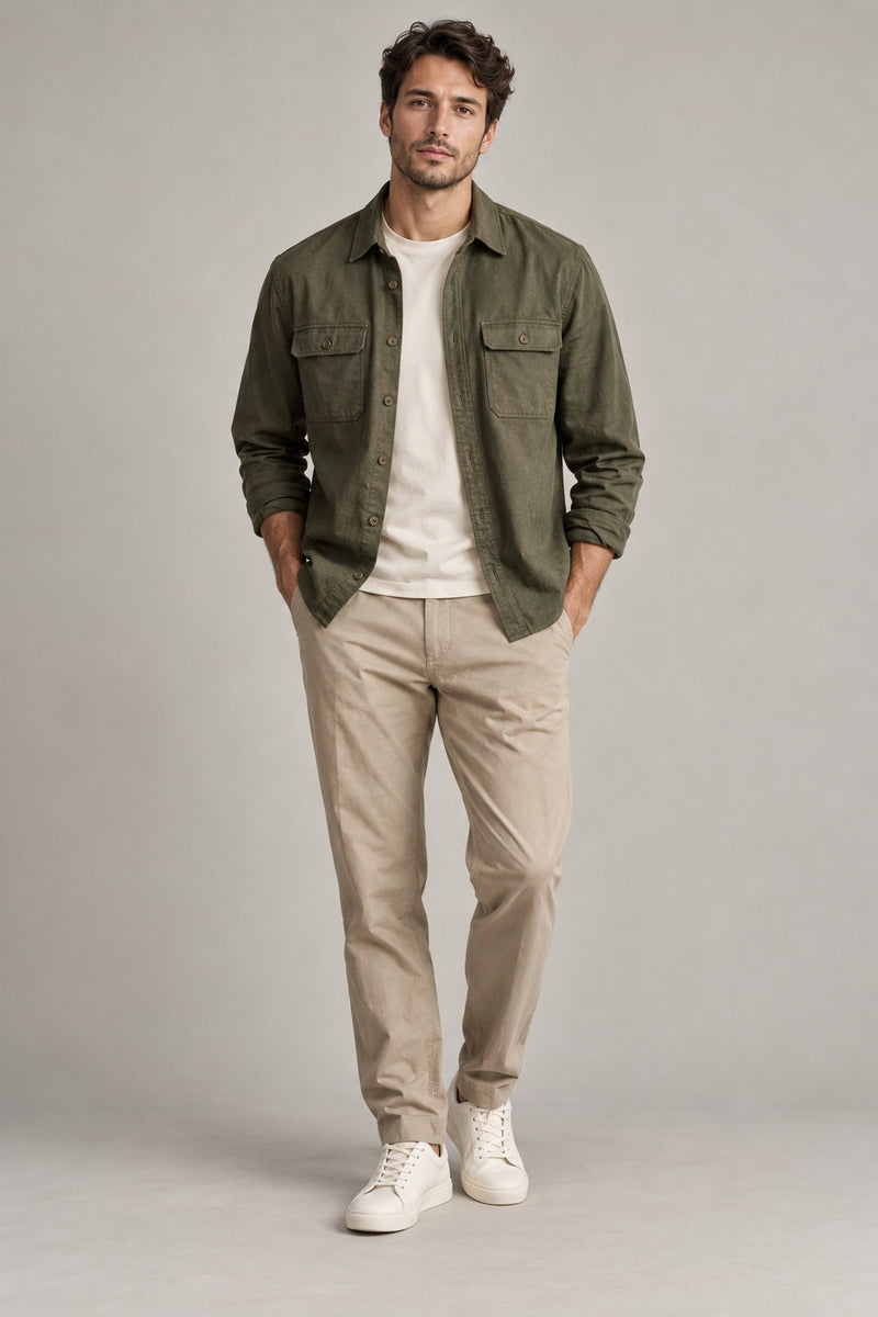 Male model wearing utility overshirt in olive on a neutral studio background